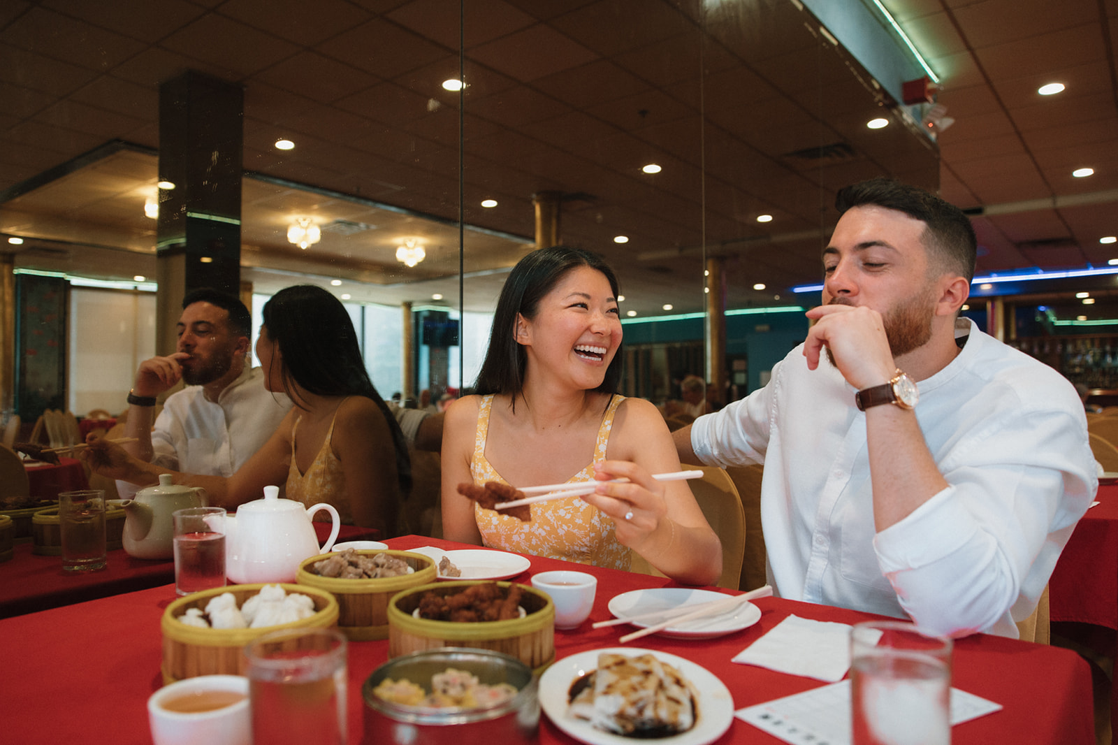 Beautiful engaged couple share a meal during their Boston engagement photos!