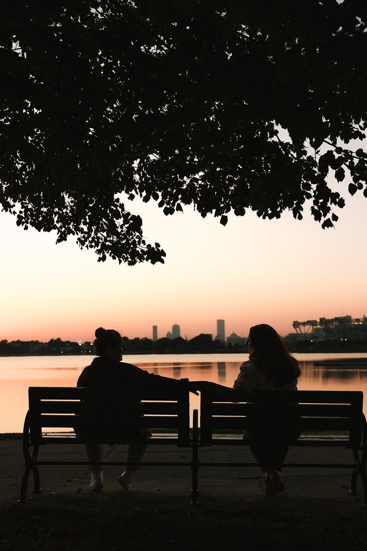 A beautiful couple share some wine by the sea during their Castle Island engagement photos