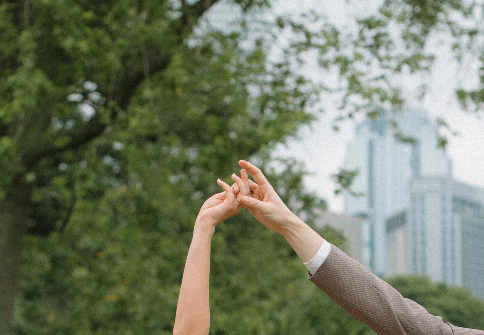 Up close detail shot of a man and woman holding hands during their Boston engagement photoshoot