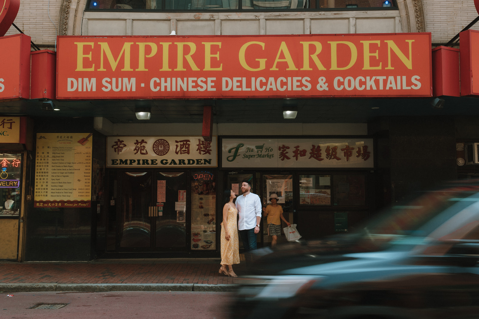 Couple pose outside Empire Garden during their Boston engagement photoshoot!