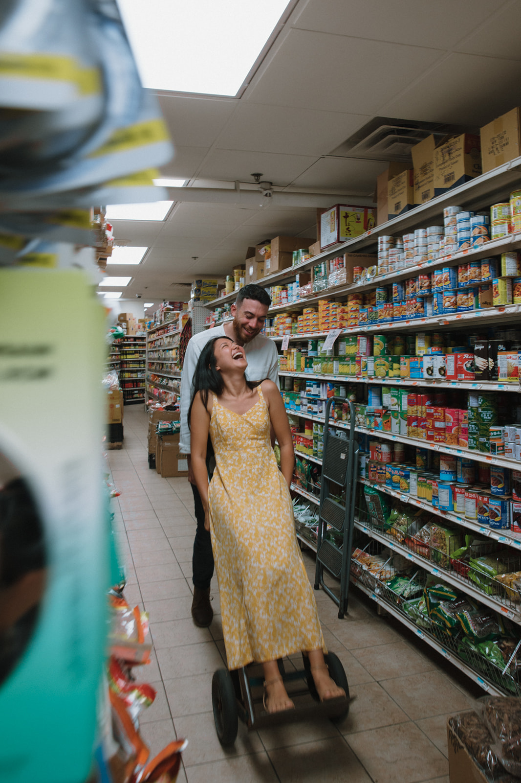 Playful couple takes a photo in a chinatown market!