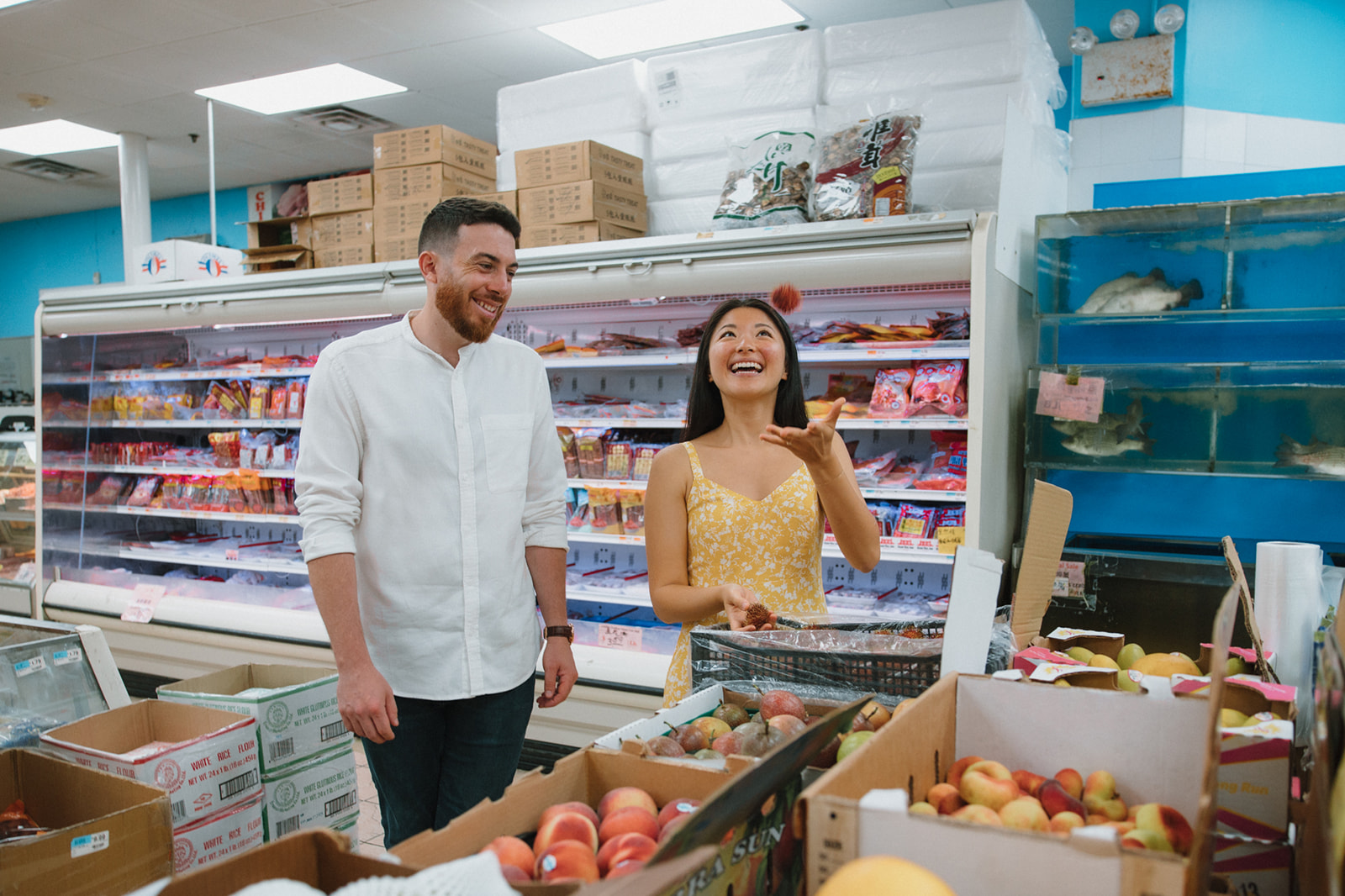 Couple take a candid photo in a chinatown market