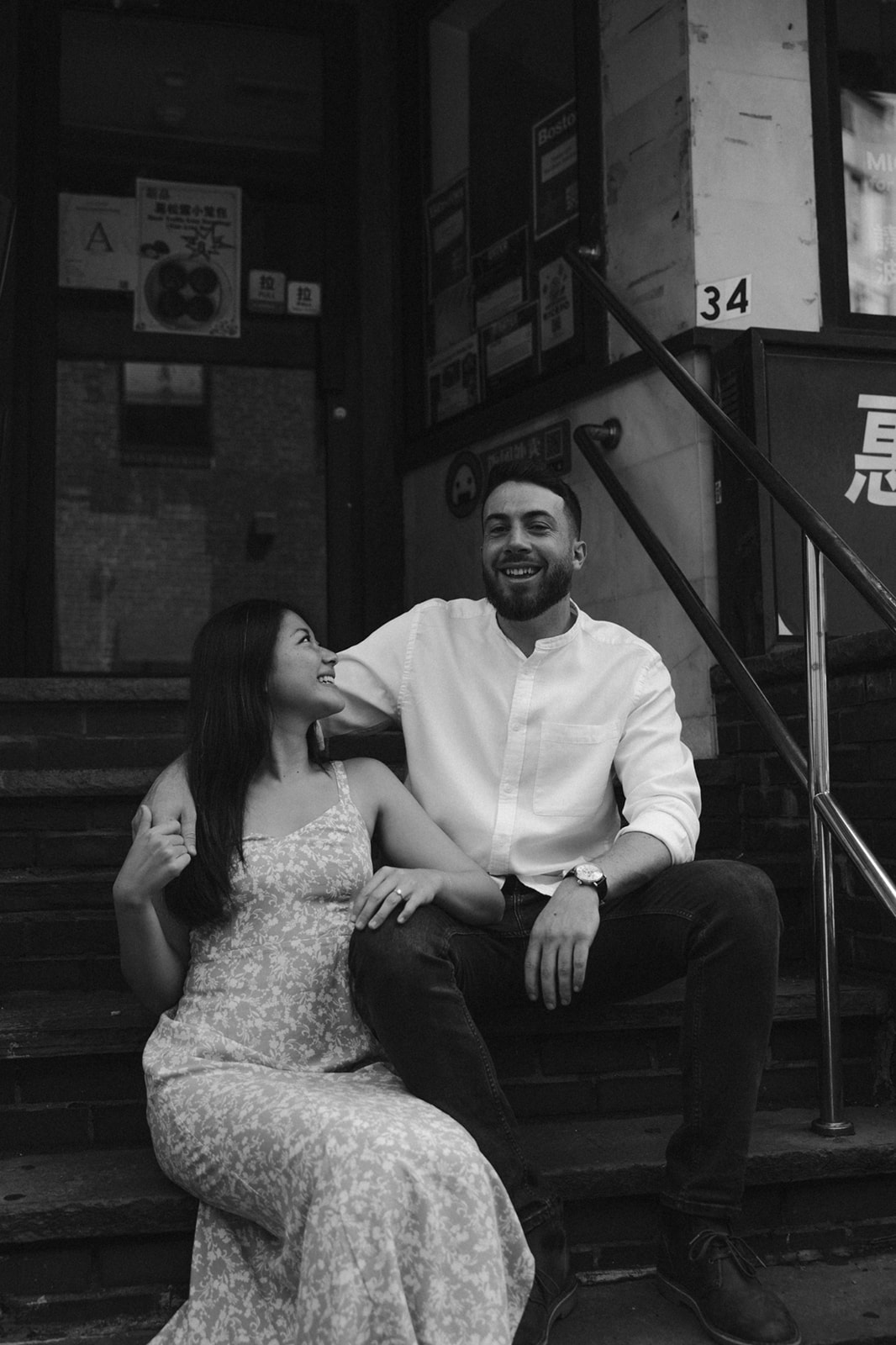 Beautiful couple share a moment on the stairs of a chinatown building