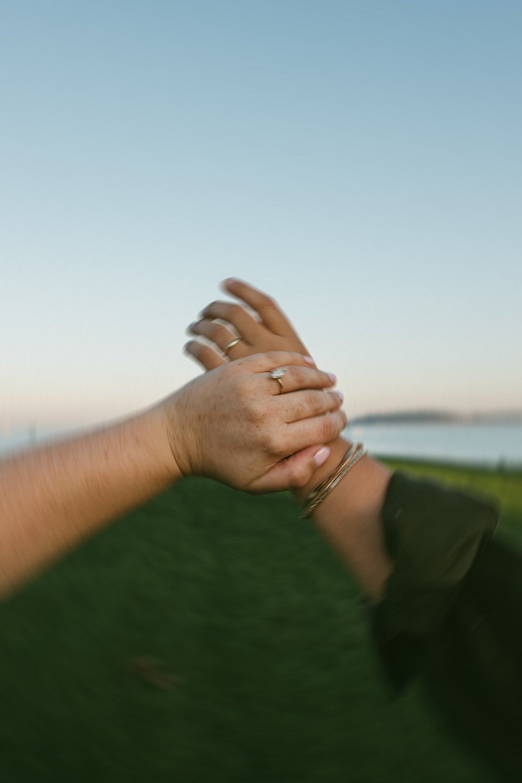 A beautiful couple hold hands by the sea during their Castle island engagement photos 