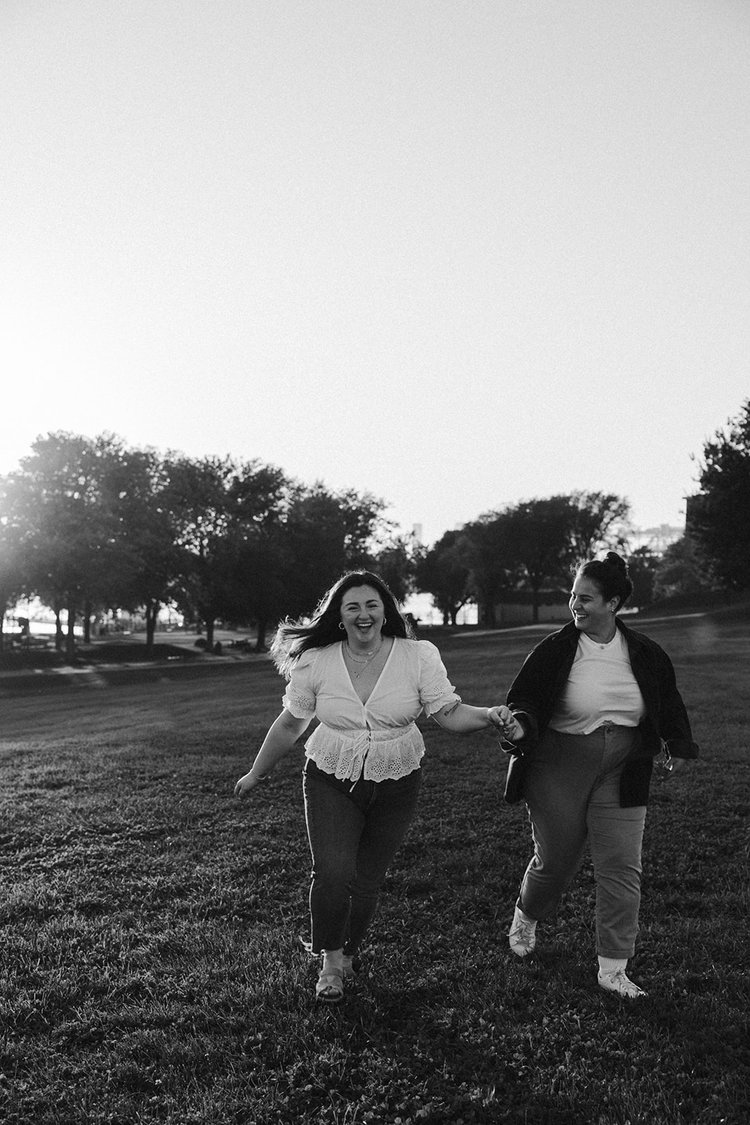 A dreamy couple holding hands and running during their Boston engagement.