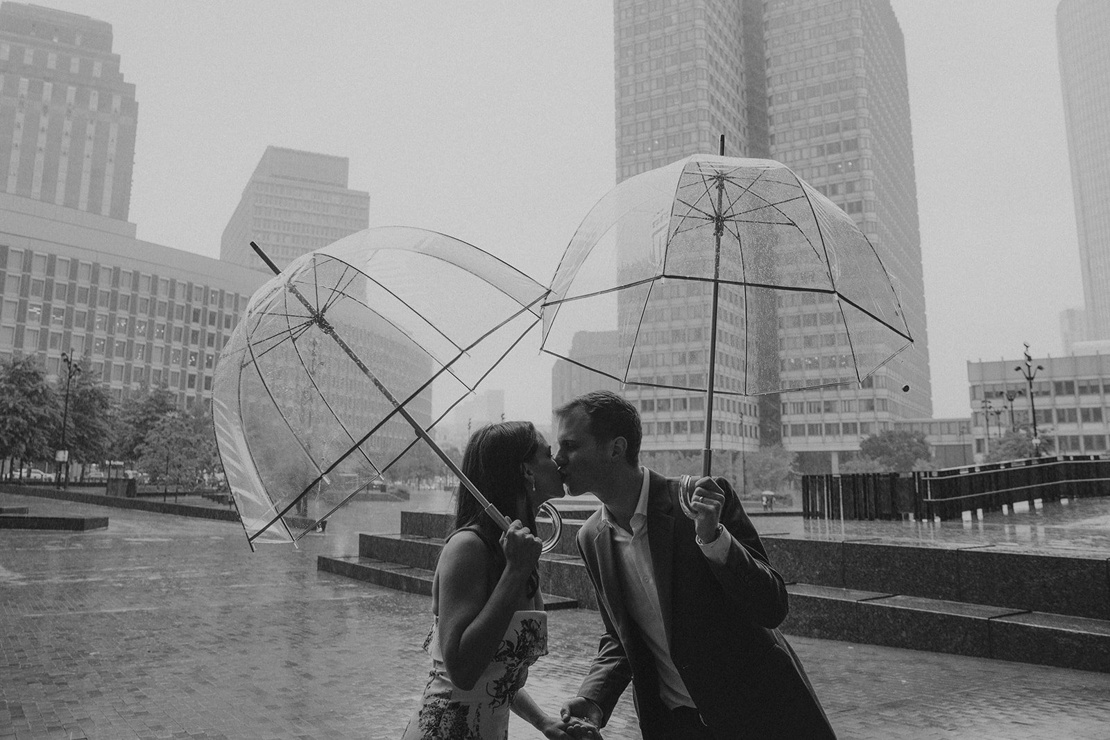 Couple pose during a rainy day in downtown Boston