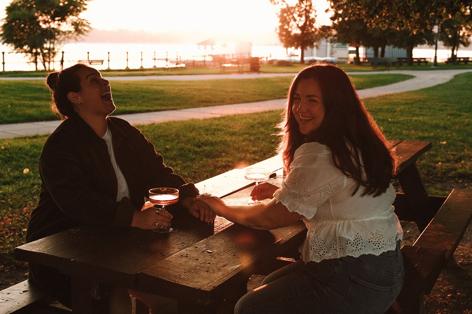 A beautiful couple share some wine by the sea during their Castle Island engagement photos