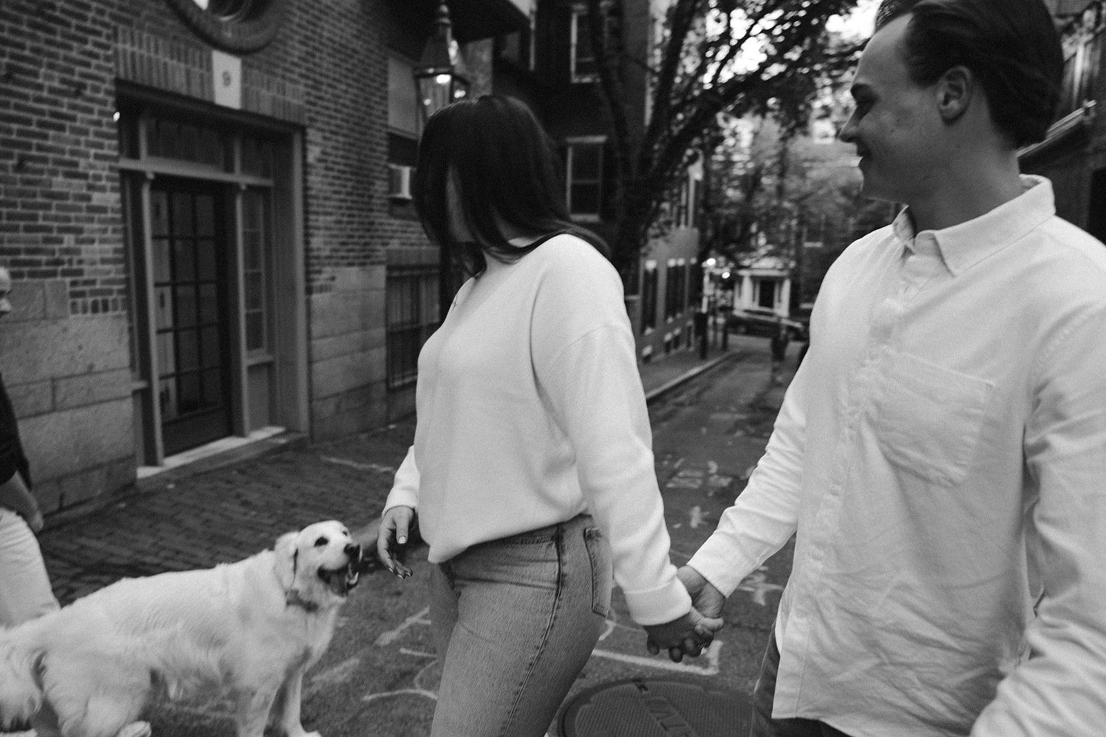 Couple walk together during their Boston engagement photos