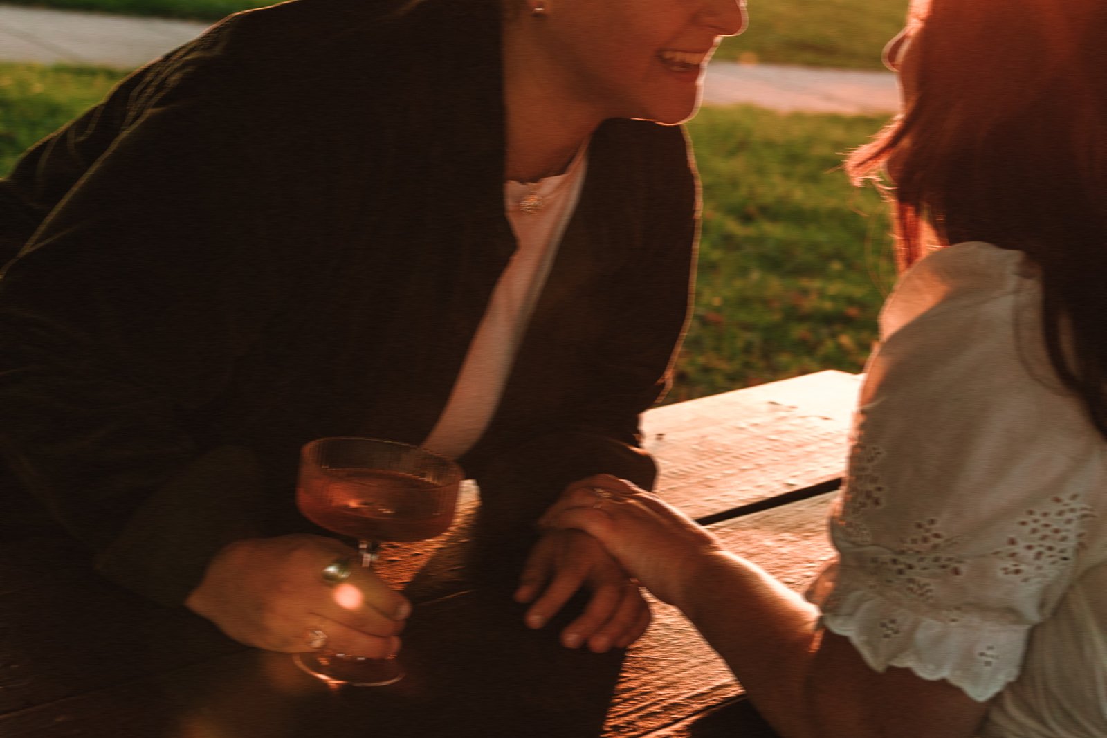 A beautiful couple share some wine by the sea during their Castle Island engagement photos