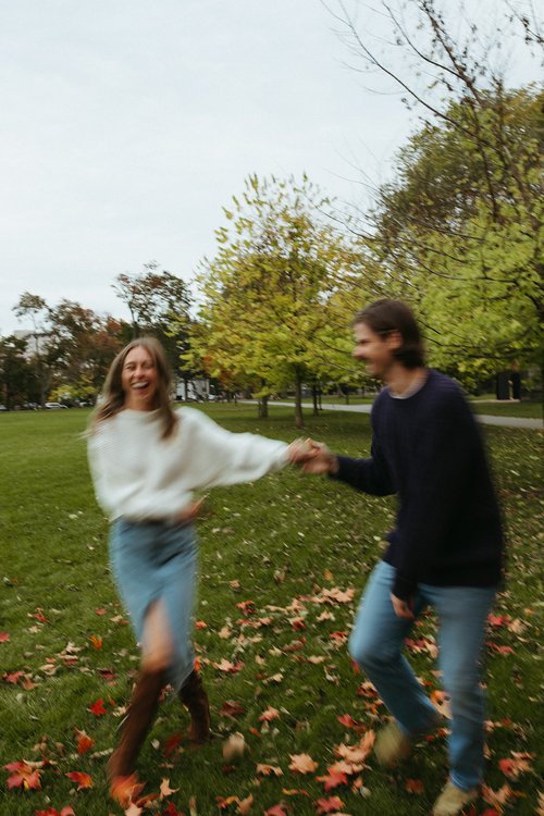 couple pose during their casual engagement photoshoot in cambridge