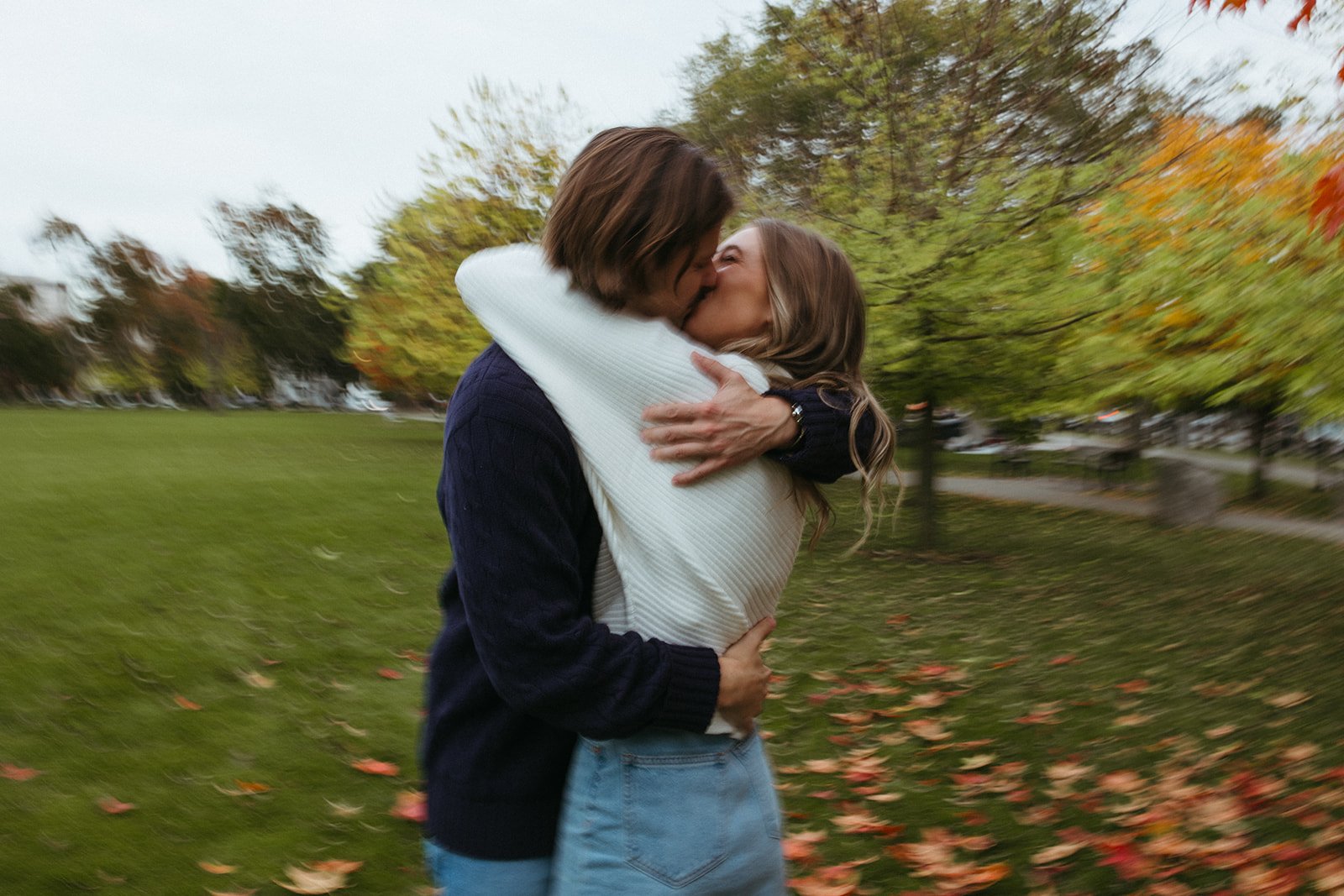 Stunning couple pose together under a colorful tree during their Boston engagement photos