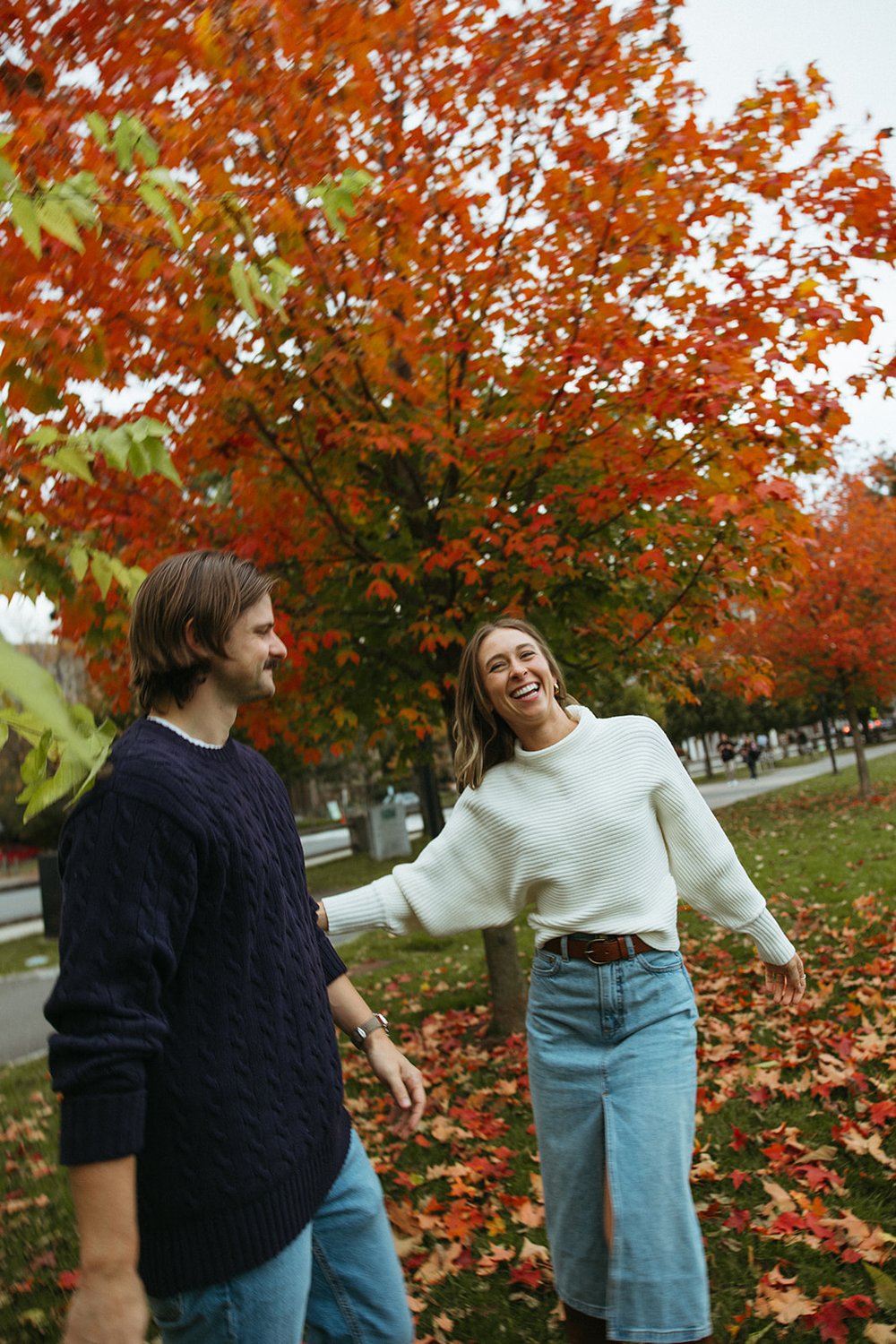 Stunning couple pose together under a colorful tree during their Boston engagement photos