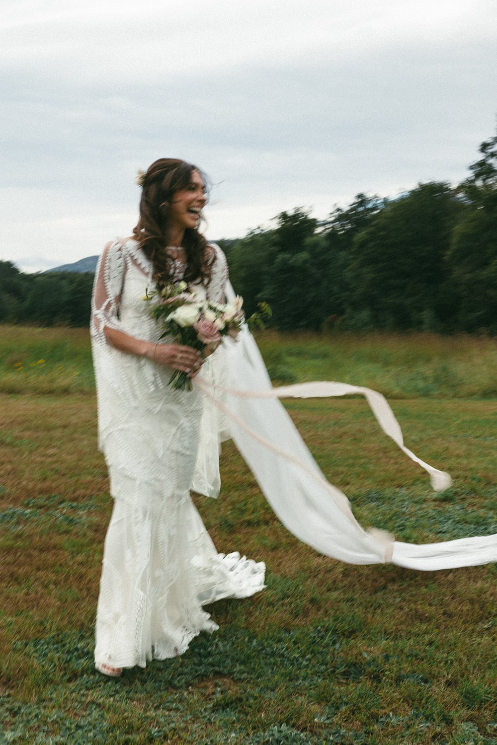 Stunning bride poses in front of the trees on her beautiful spring wedding day