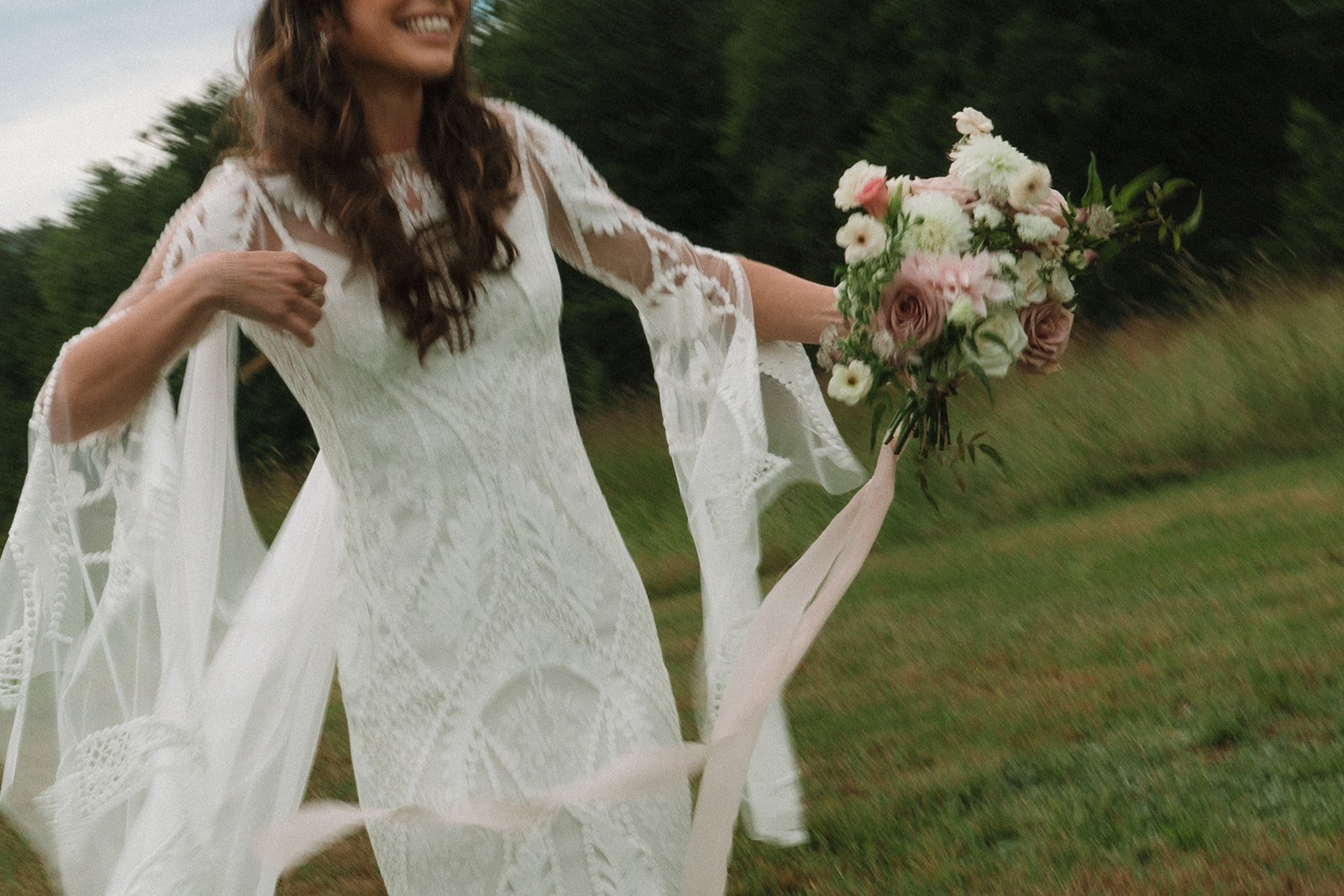 Stunning bride poses in front of the trees on her beautiful spring wedding day