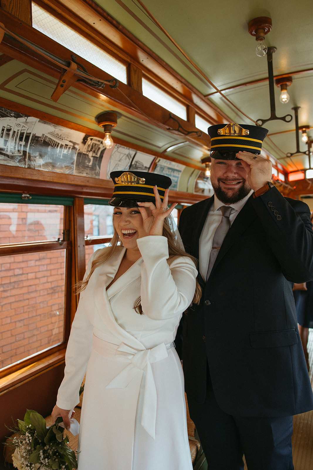 Stunning bride and groom pose on the trolley together