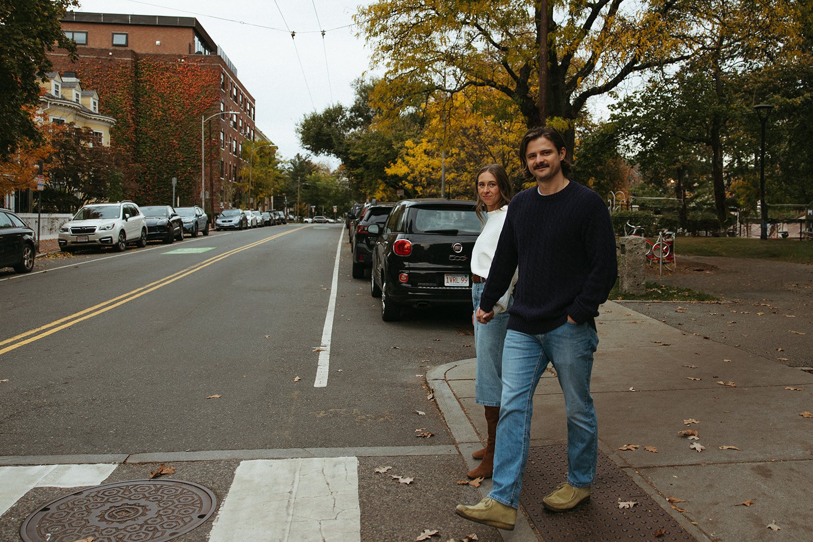 Stunning couple pose on a street in front of beautiful New England homes during their Boston engagement photos