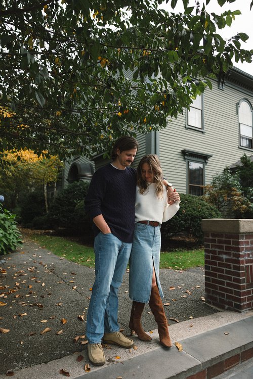 Stunning couple pose together in front of a beautiful New England home during their Boston engagement photos