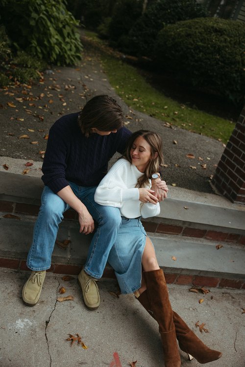 Stunning couple pose together in front of a beautiful New England home during their Boston engagement photos