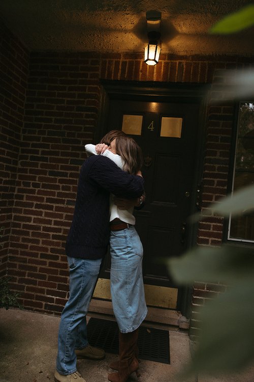 Stunning couple pose together in front of a beautiful New England home during their Boston engagement photos