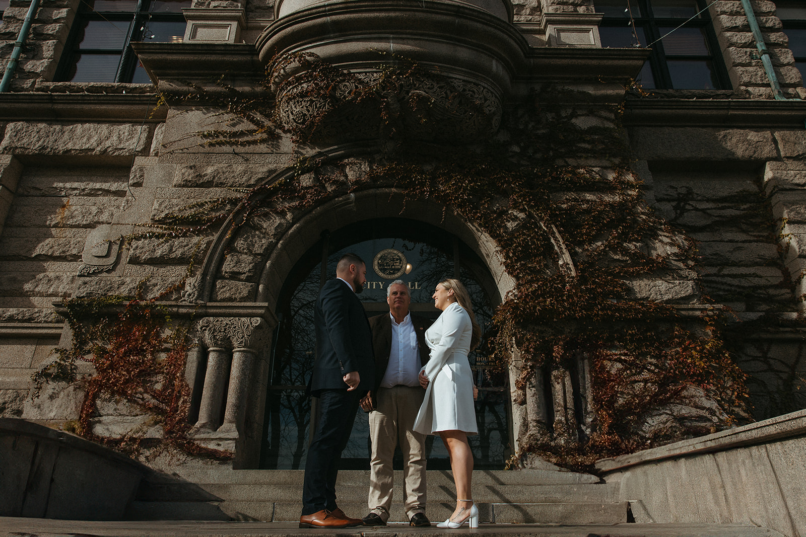 Stunning bride and groom pose outside city hall as they elope in Massachusetts 