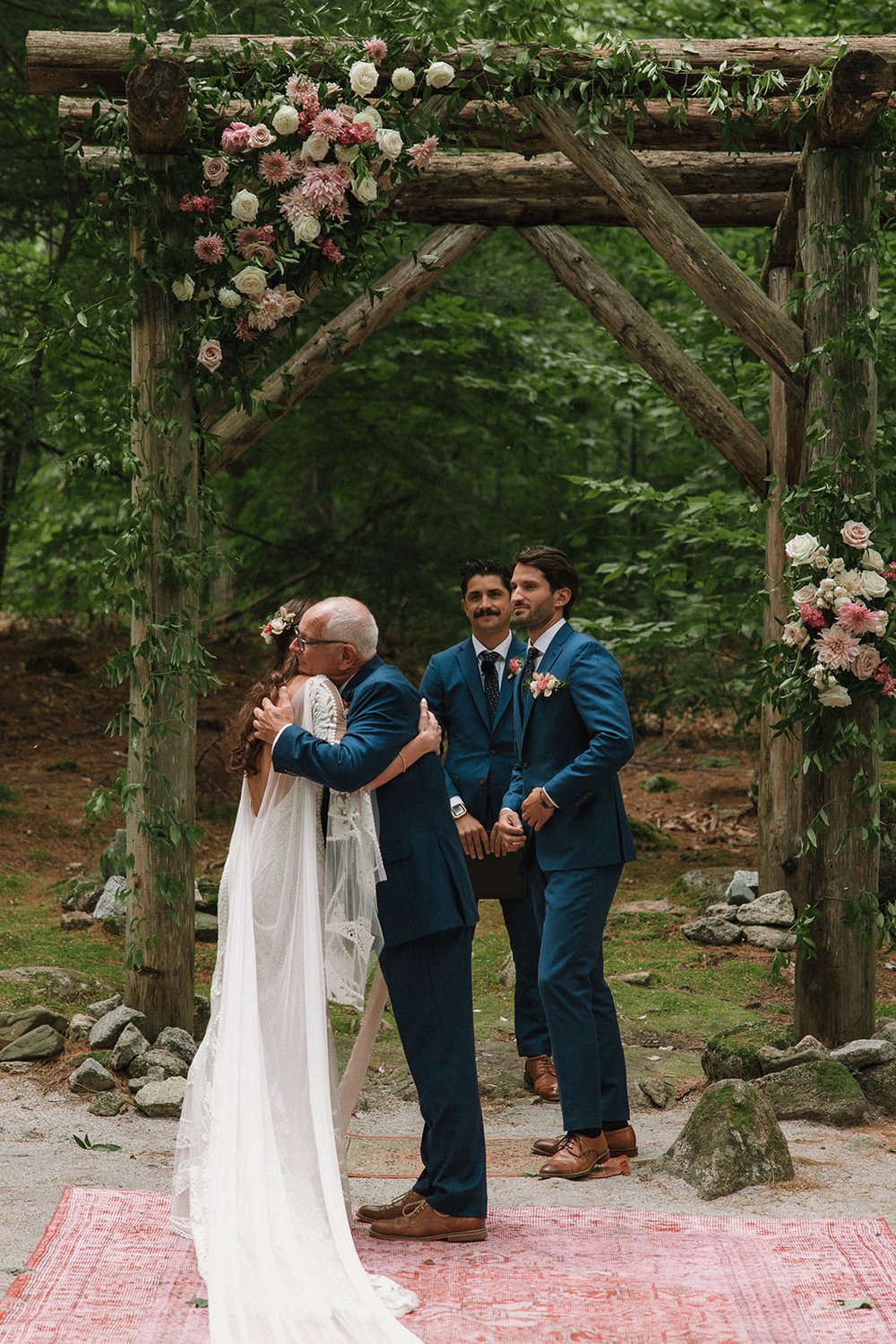 Father passes along his daughters hands on her dreamy wedding day