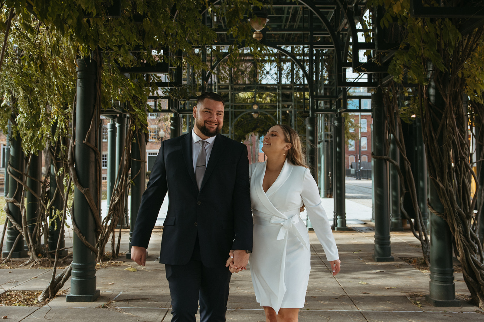 Stunning bride and groom pose outside city hall after they elope in Massachusetts