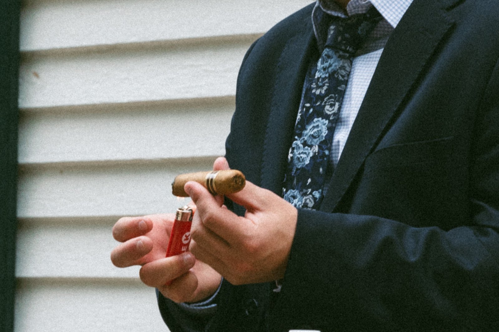 Groom smokes a cigar on his dreamy spring wedding day