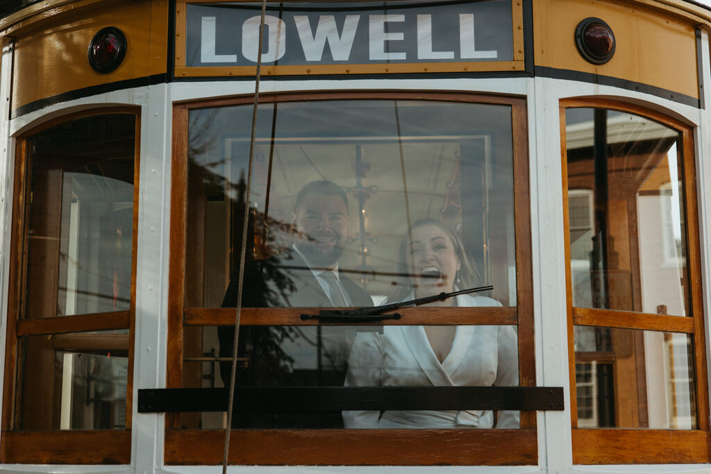 Stunning bride and groom pose on the trolley together