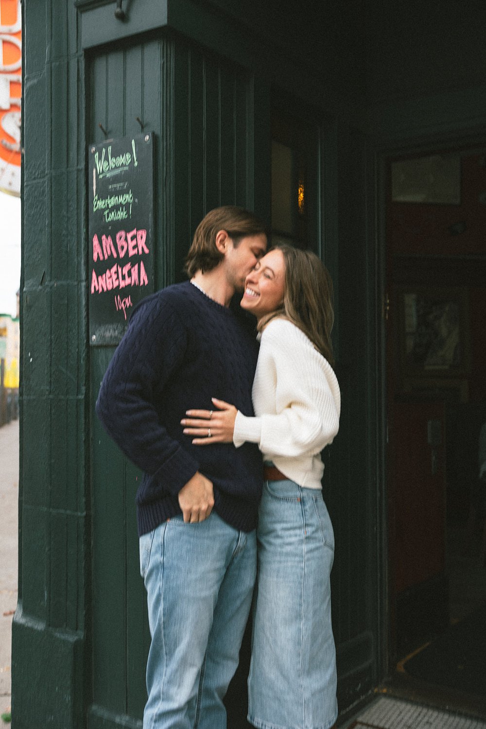 Beautiful couple pose on the street together during their Boston engagement photoshoot