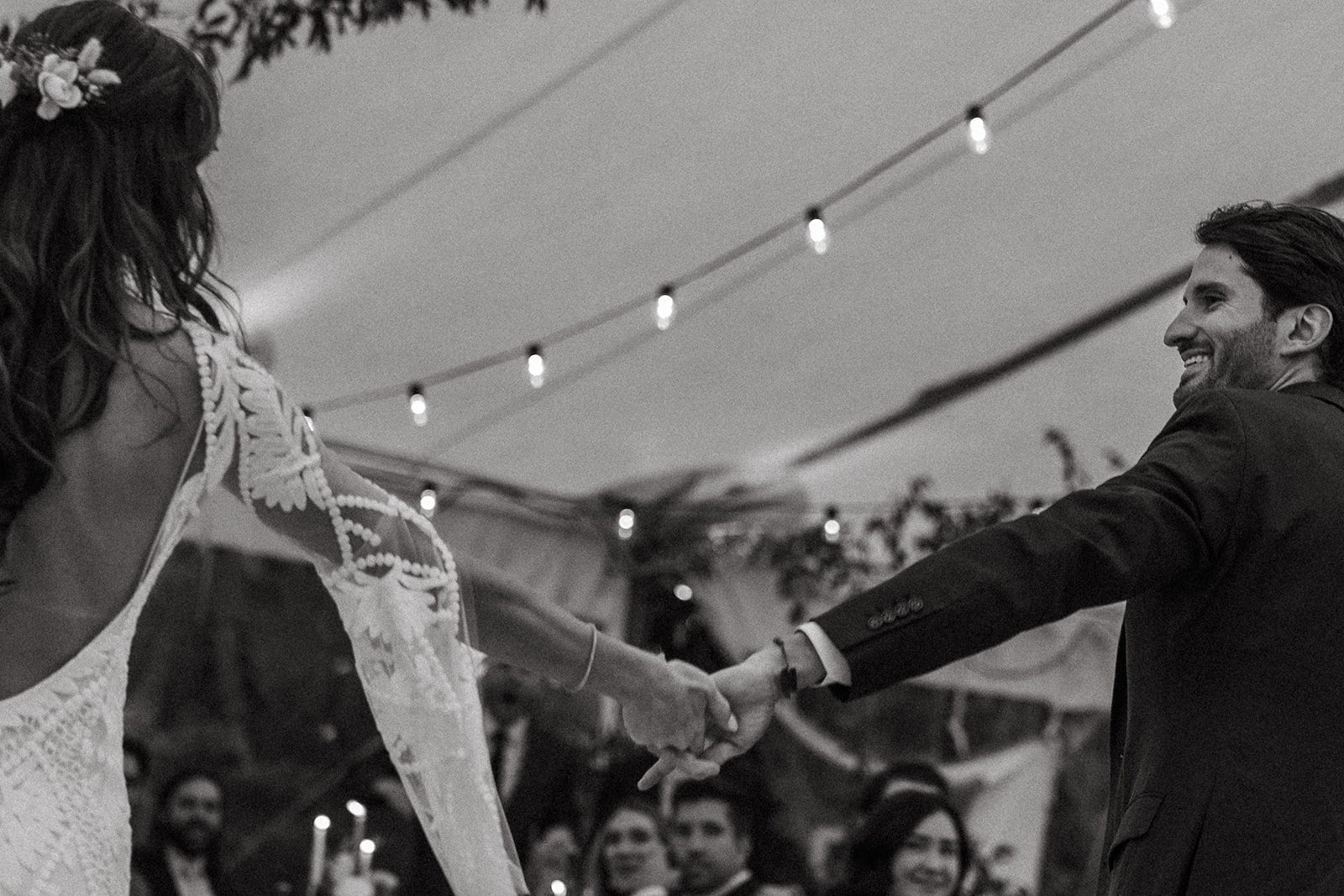 Bride and groom share a dance as their guest look on