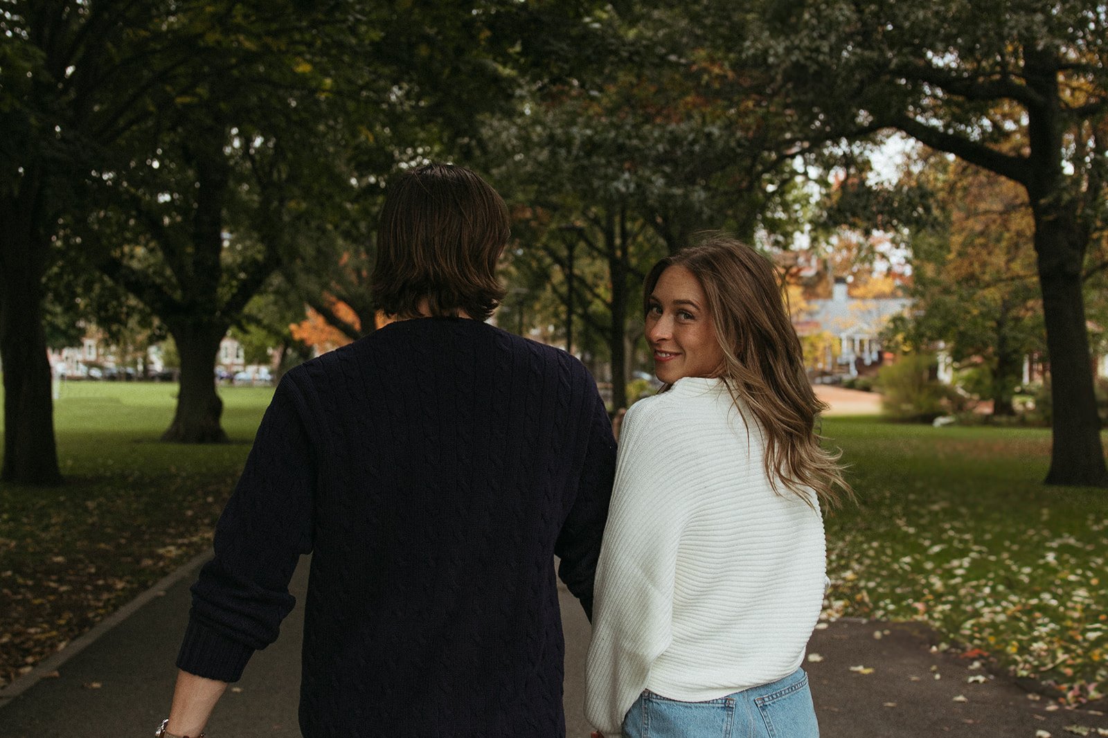 couple pose during their casual engagement photoshoot in cambridge