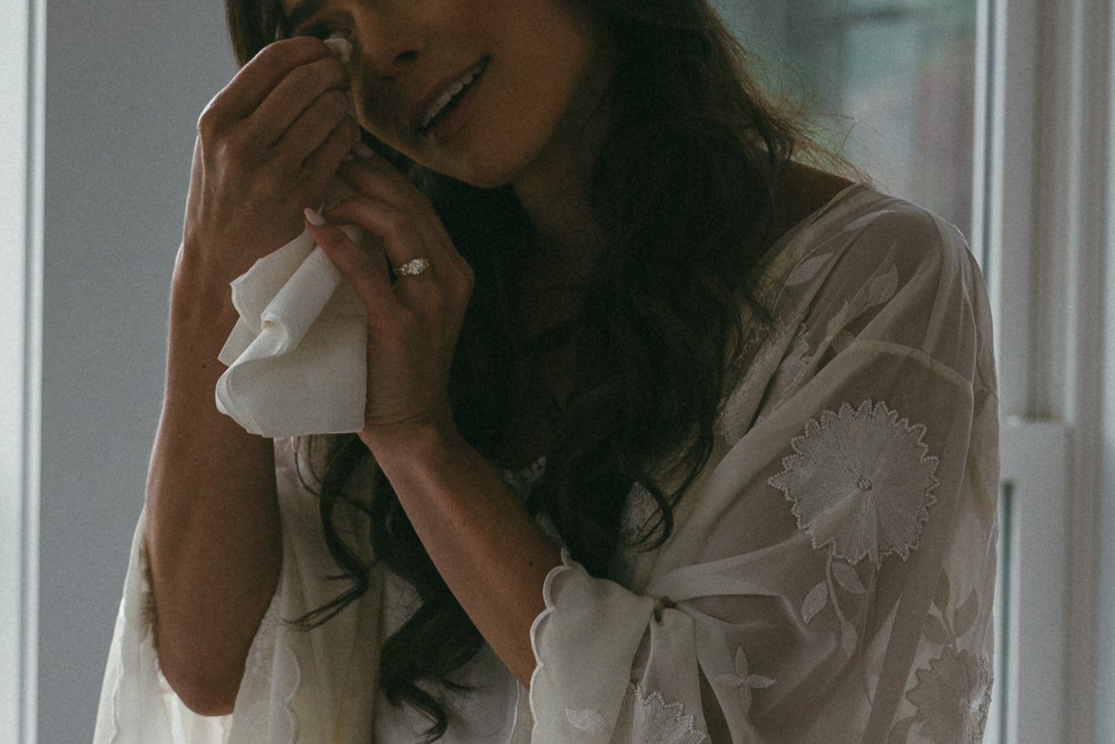 bride sheds a tear as she finalizes prep for her dreamy wedding day