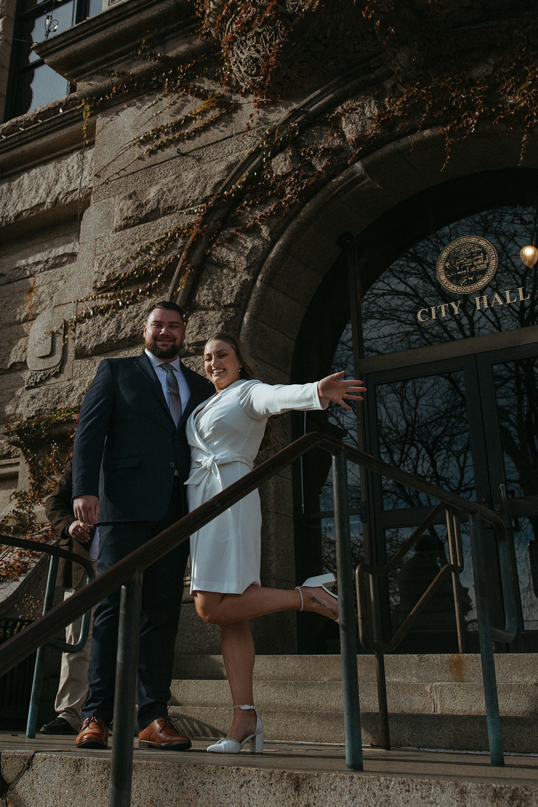 Stunning bride and groom pose outside city hall after they elope in Massachusetts