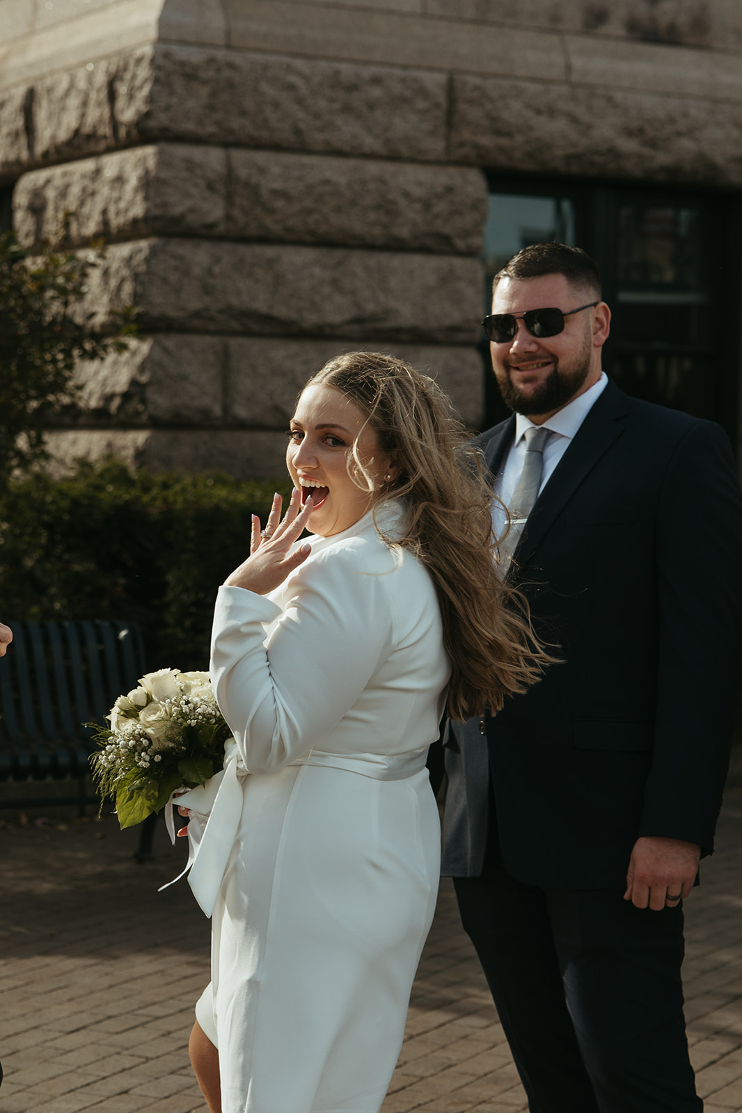 Stunning bride and groom pose outside city hall after they elope in Massachusetts