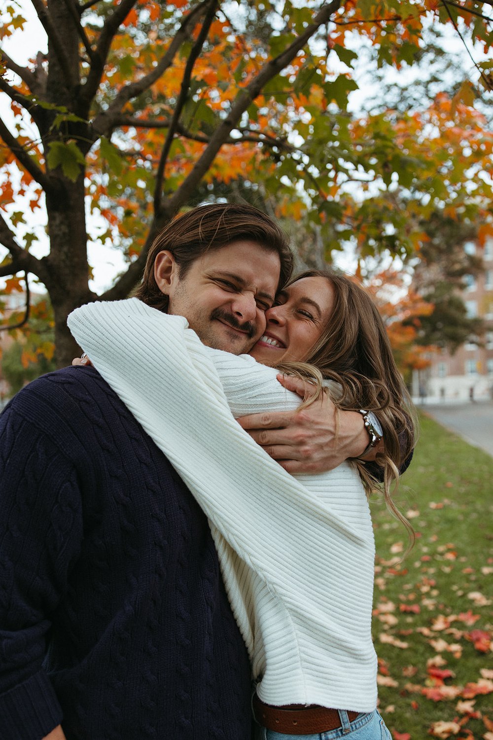 Stunning couple pose together under a colorful tree during their Boston engagement photos