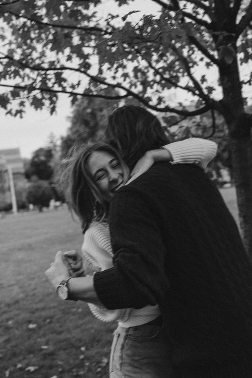 couple pose during their casual engagement photoshoot in cambridge