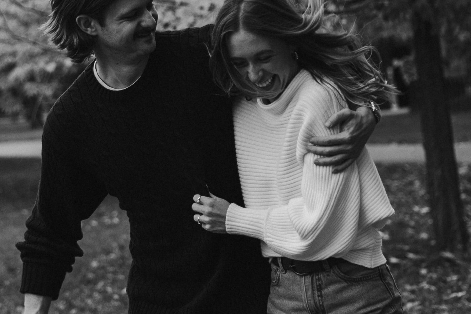 couple pose during their casual engagement photoshoot in cambridge