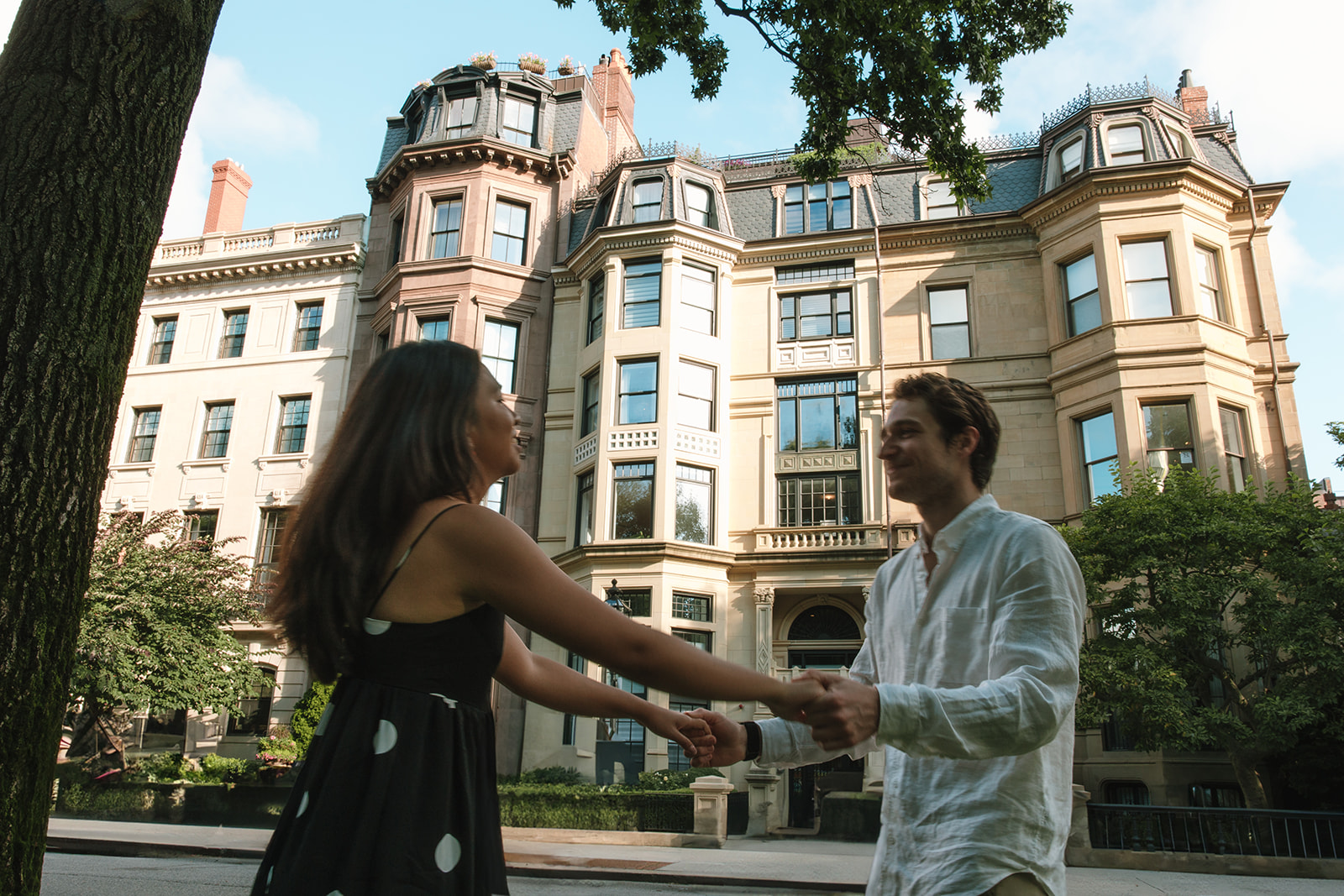 couple spinning around in downtown boston