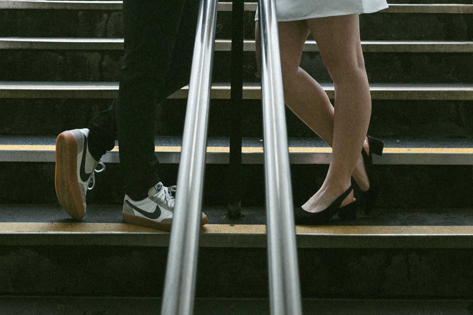 Beautiful couple pose on the Boston subway entrance during their engagement photos in Boston!