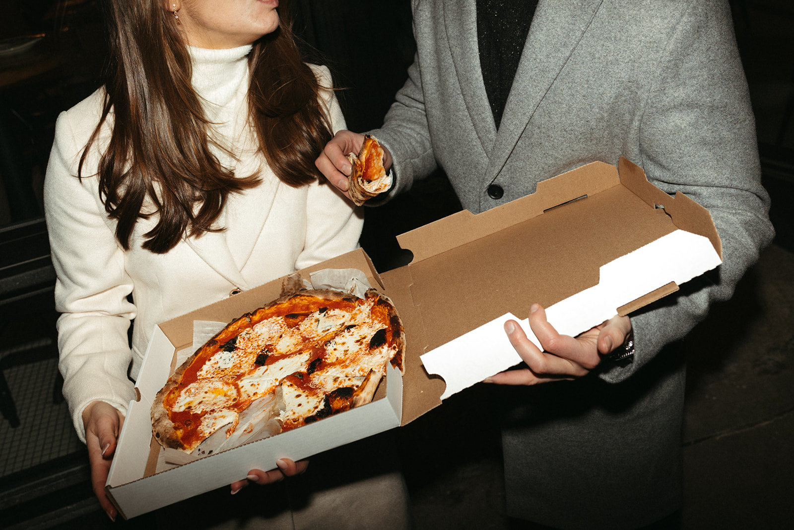 Stunning couple share a pizza together 