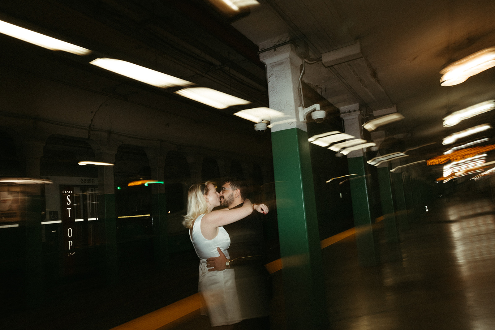 Stunning couple pose with Boston subway in the background