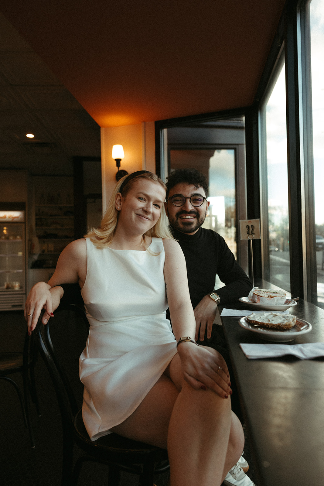 Stunning couple pose in a Boston diner together during their engagement photos in Boston!