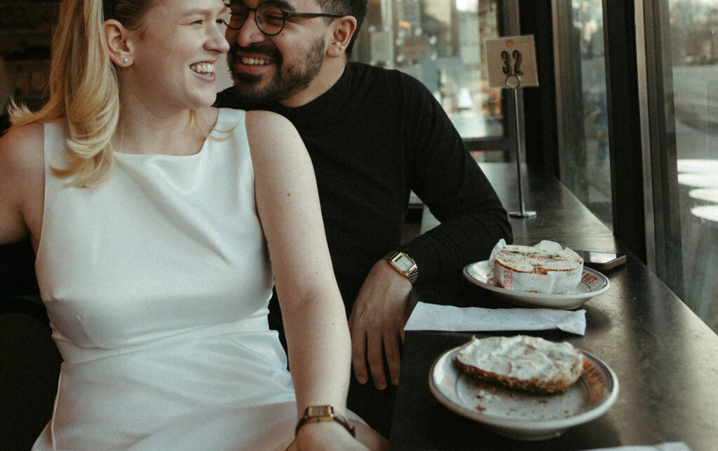 Stunning couple pose in a Boston diner together during their engagement photos in Boston!