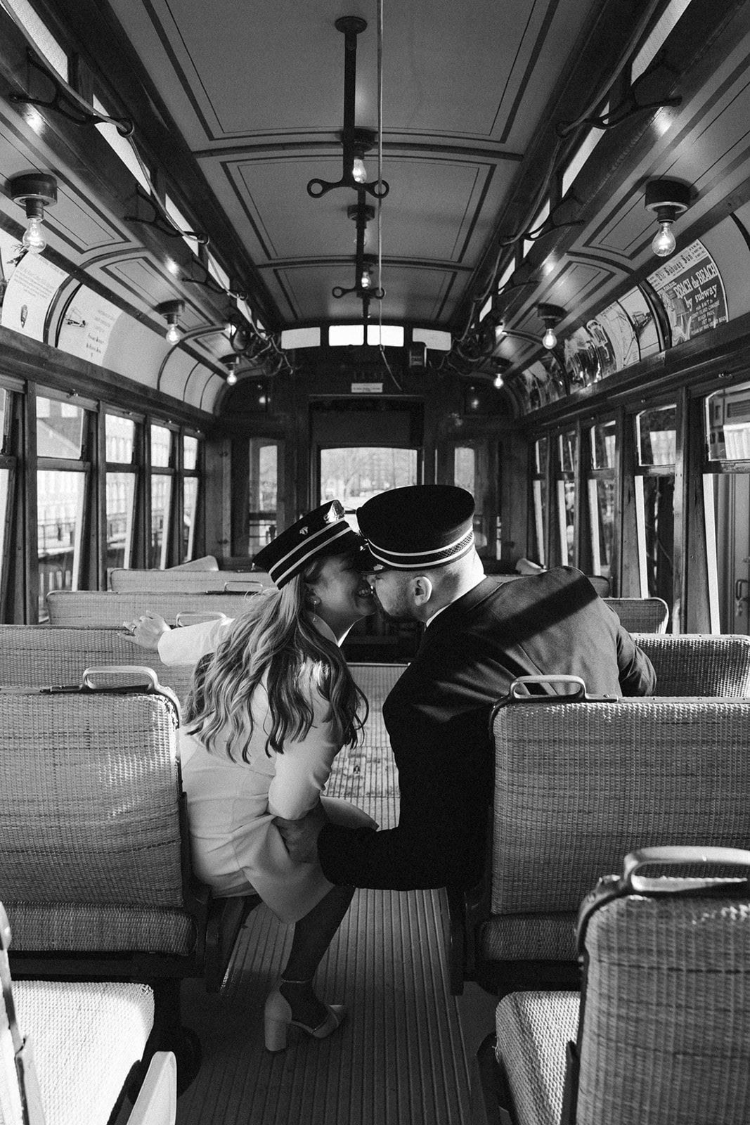 bride and groom share a kiss on the Boston trolley