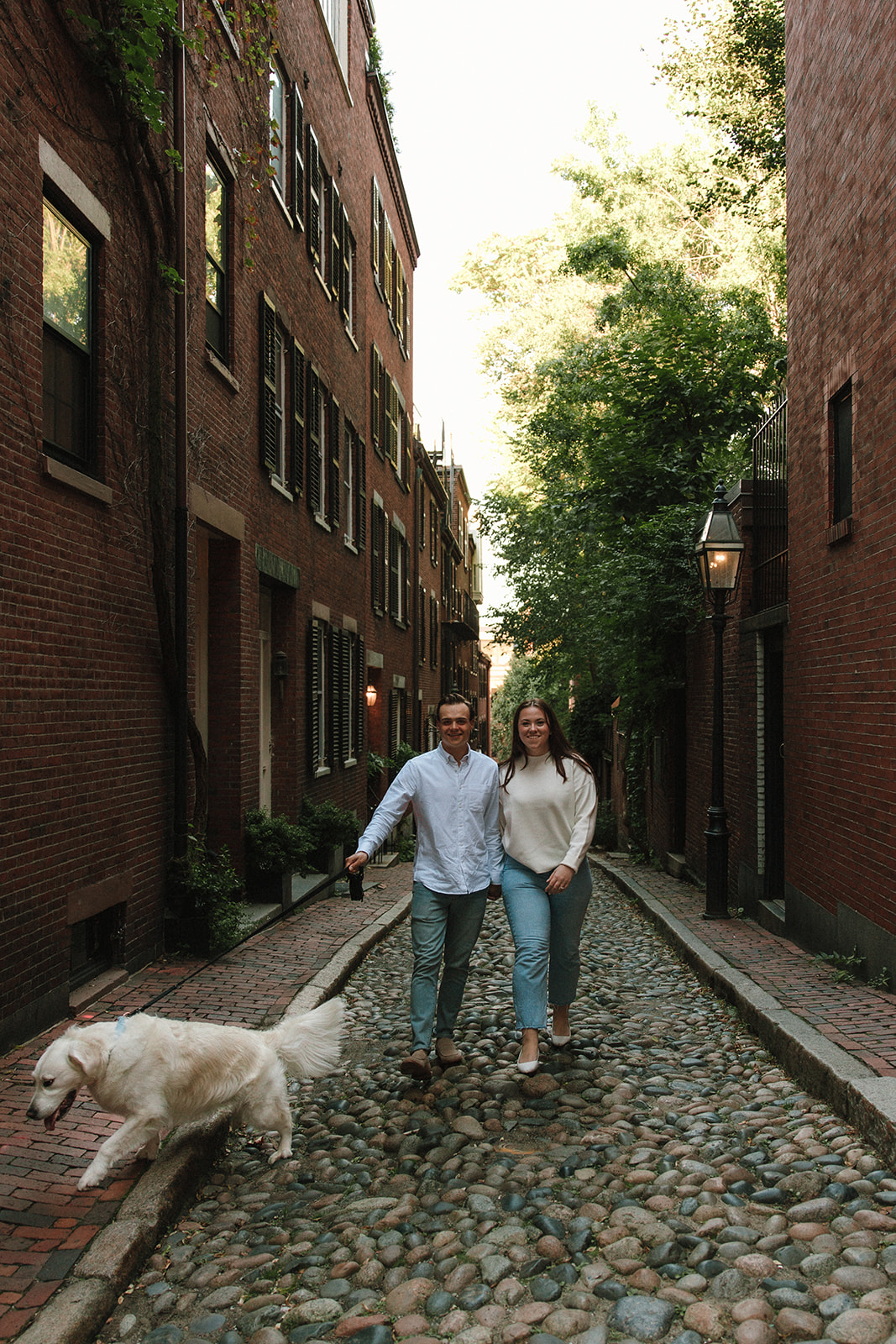 stunning couple walk their dog together 