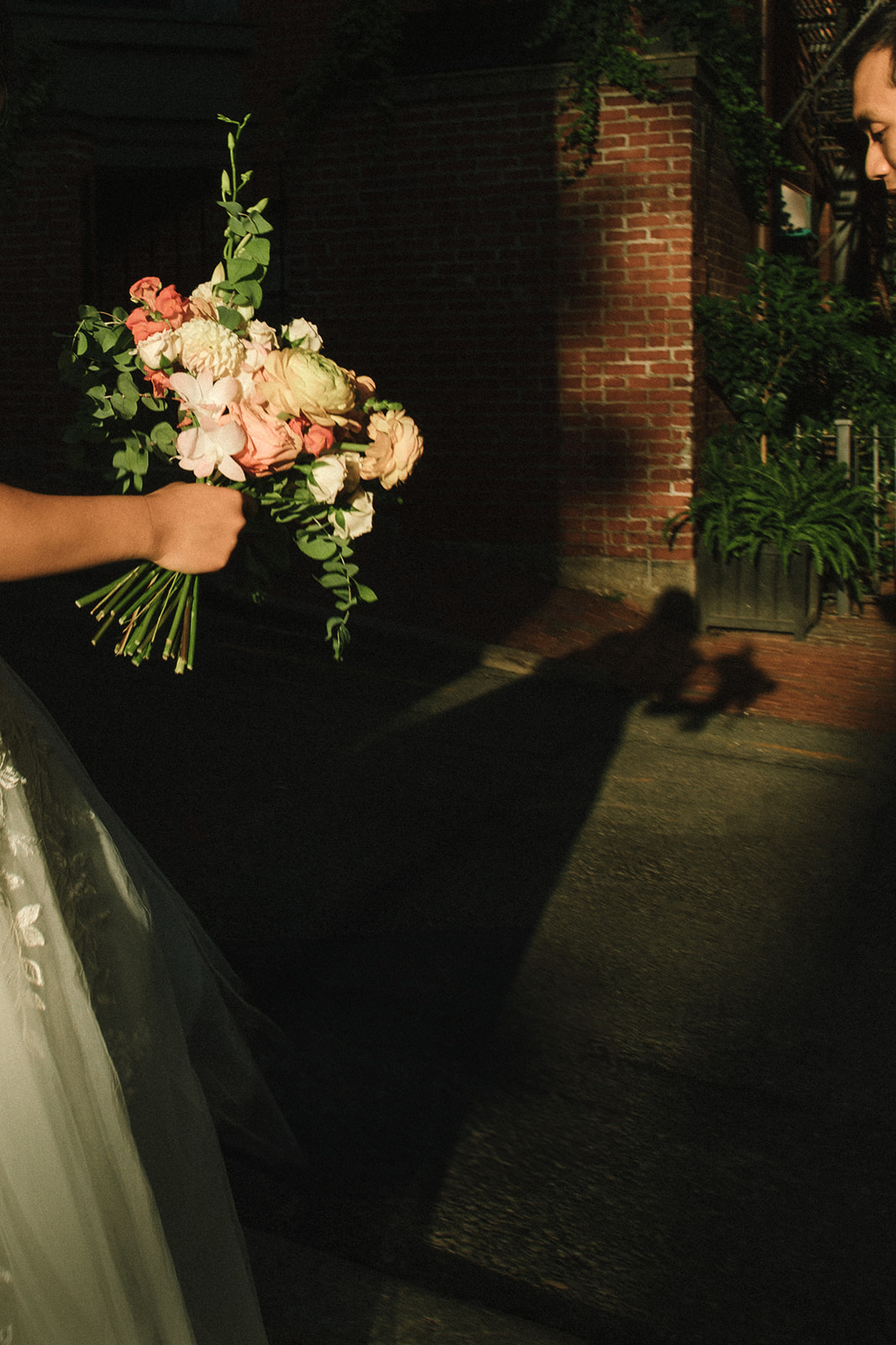 bride holding her bouquet of flowers with stunning lighting