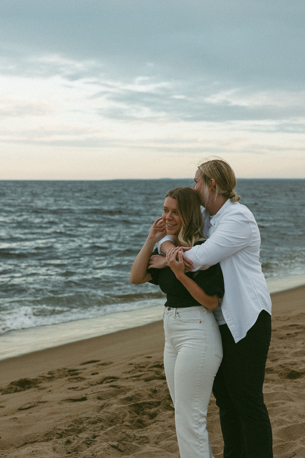 stunning couple pose on the beach together captured by their Boston wedding photographer