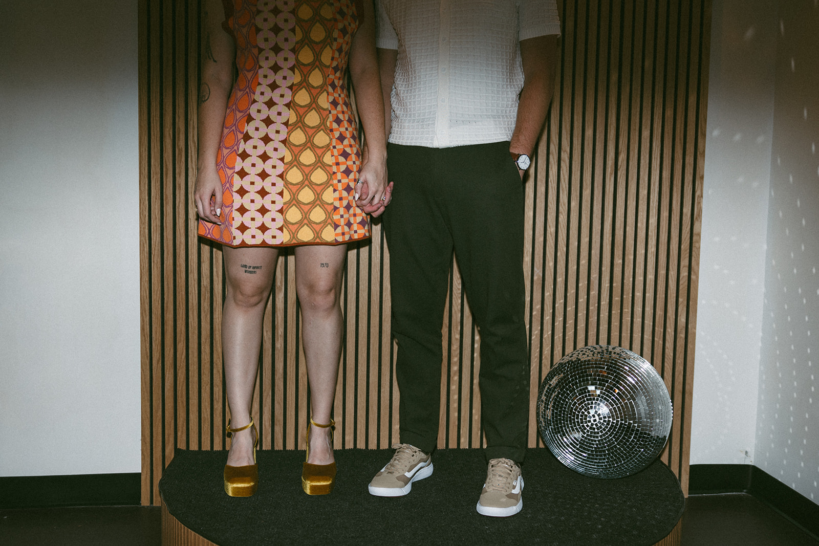 couple pose with their disco ball