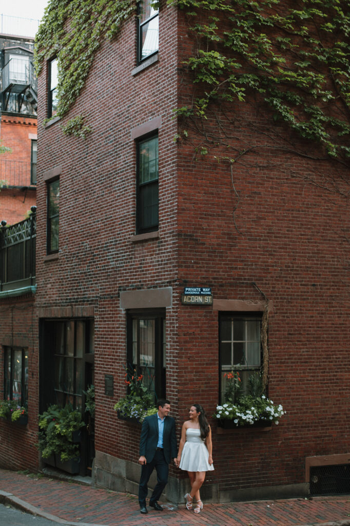 Couple poses for engagement photos on acorn street in beacon hill