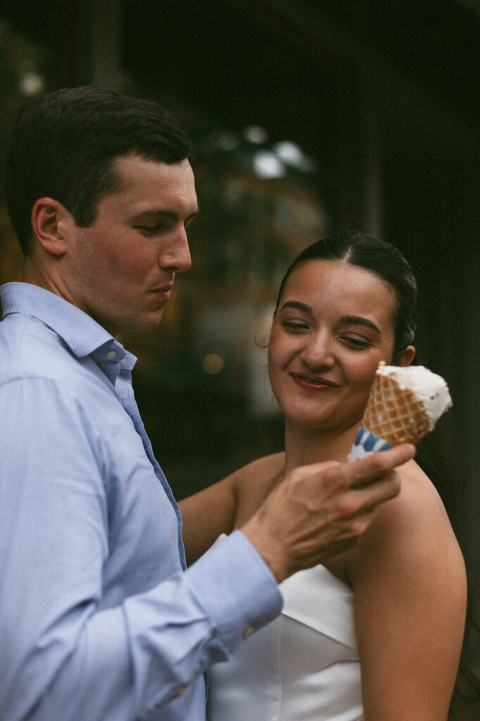 couple eats ice cream during engagement photos in boston